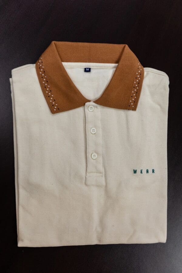 White polo shirt with brown collar and "WEAR" logo.