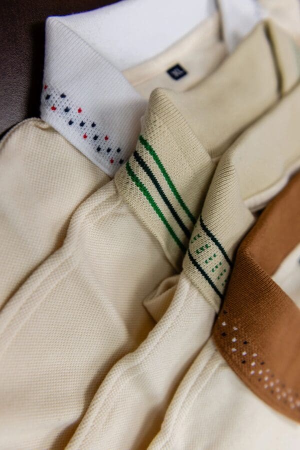 Close-up of white and brown polo shirts.