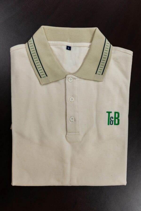 Beige polo shirt with green T&B logo.