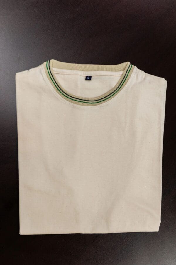 White t-shirt with green and black trim.