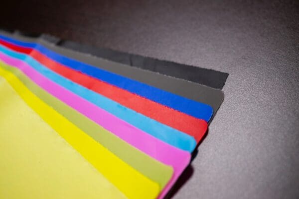 Stack of colorful fabric swatches.